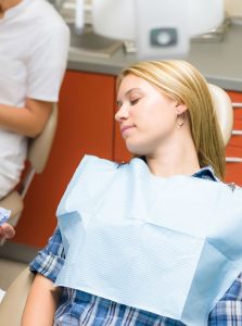 Woman asleep in a dental chair