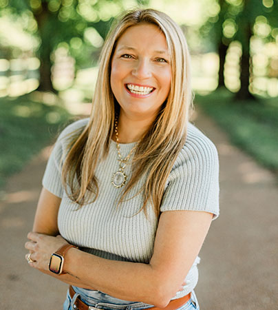 Photo of Brittney smiling outdoors.