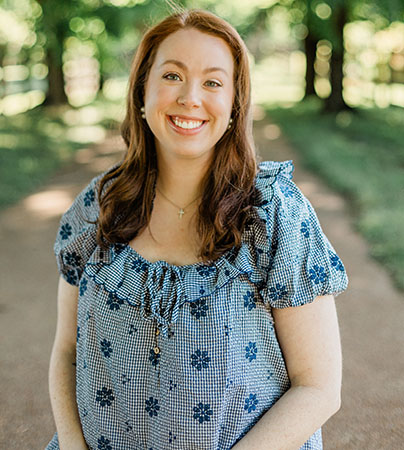 Photo of Kasey smiling outdoors.